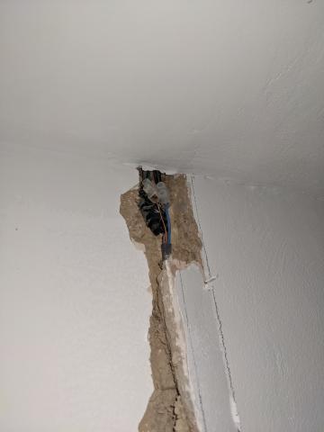 Poorly done joint found on a recent lighting re-wire. Single insulated cables outside of a junction box and just taped up buried in a wall.