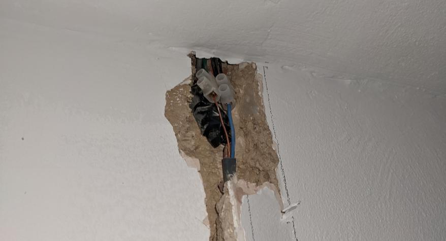 Poorly done joint found on a recent lighting re-wire. Single insulated cables outside of a junction box and just taped up buried in a wall.